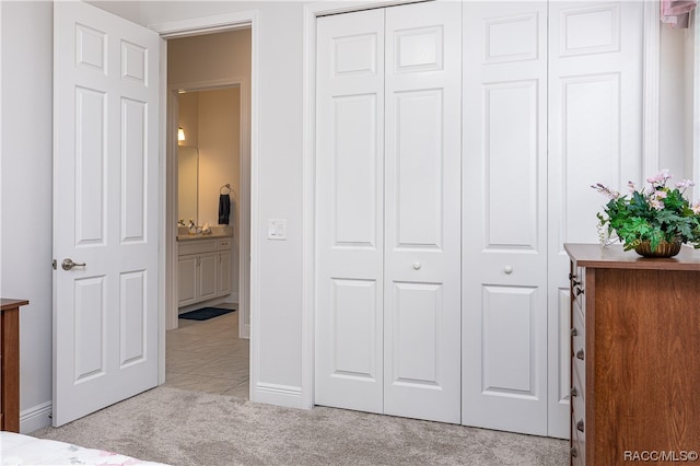 unfurnished bedroom with sink and light carpet