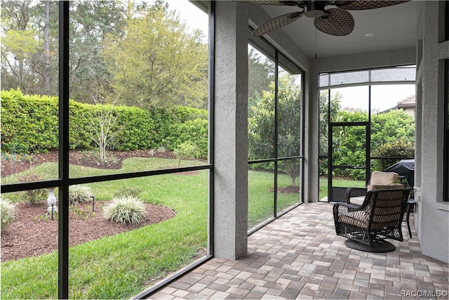 sunroom / solarium featuring ceiling fan