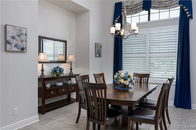 dining area featuring a chandelier and light tile patterned floors