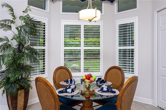 tiled dining space with a healthy amount of sunlight