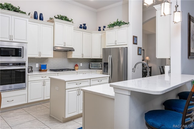 kitchen featuring kitchen peninsula, hanging light fixtures, white cabinets, and stainless steel appliances