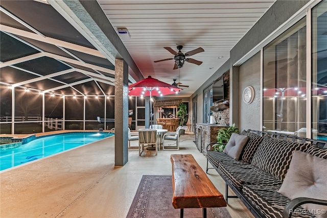 pool featuring glass enclosure, a patio, ceiling fan, and outdoor dining space