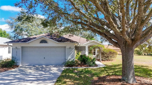 view of front of home featuring a garage and a front lawn