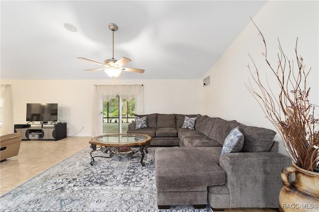 living room with ceiling fan and tile patterned flooring