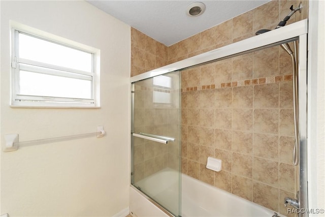 bathroom with combined bath / shower with glass door