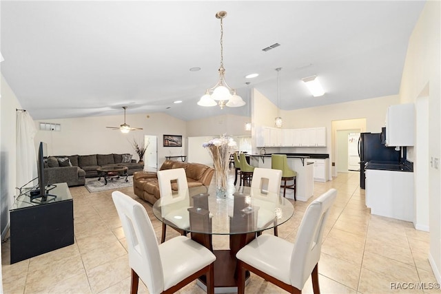 tiled dining area featuring ceiling fan with notable chandelier and vaulted ceiling