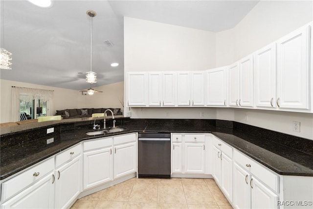 kitchen featuring pendant lighting, sink, dishwasher, white cabinetry, and dark stone countertops