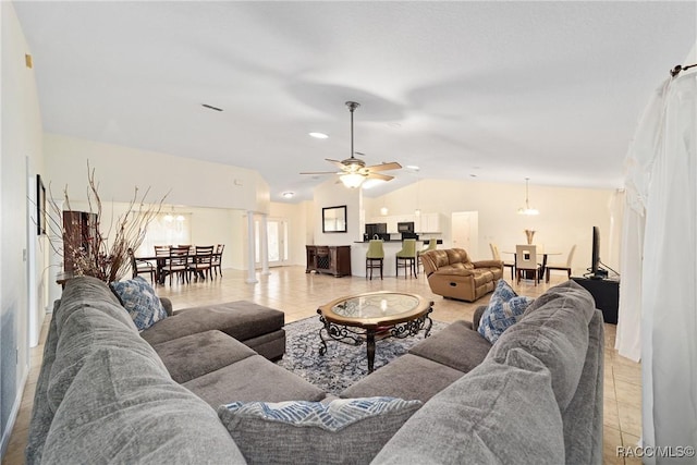 living room with vaulted ceiling, light tile patterned floors, and ceiling fan