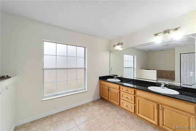 bathroom with vanity and a bath