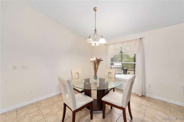 dining area with light tile patterned floors and a notable chandelier