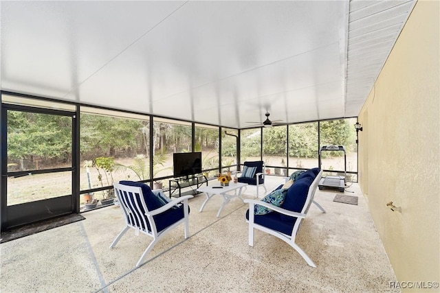 unfurnished sunroom with ceiling fan