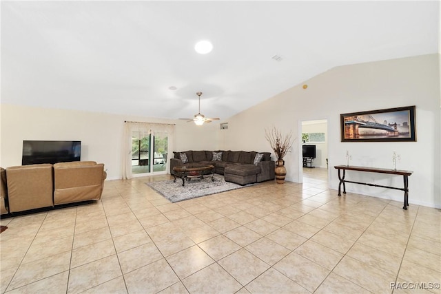 tiled living room with ceiling fan and vaulted ceiling