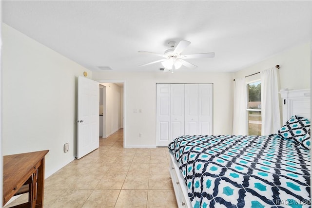 tiled bedroom with ceiling fan and a closet