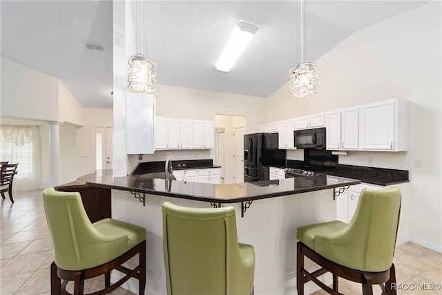 kitchen with a breakfast bar area, pendant lighting, kitchen peninsula, and black appliances