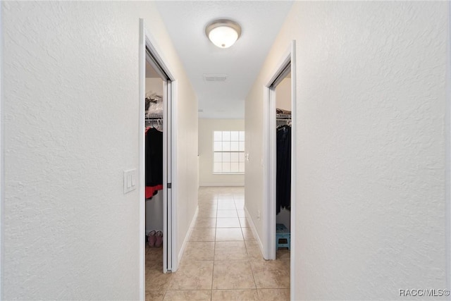 hallway featuring light tile patterned flooring