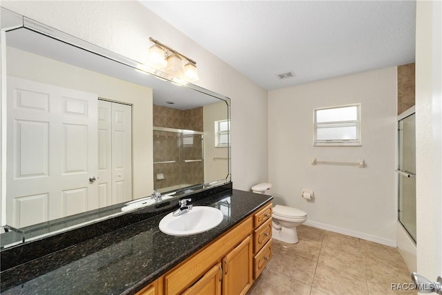 full bathroom with vanity, plenty of natural light, tile patterned floors, and toilet