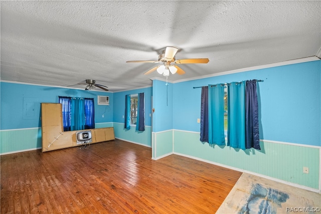 interior space featuring hardwood / wood-style floors, crown molding, a textured ceiling, and heating unit