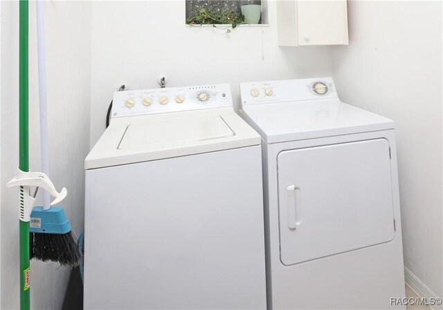 washroom with washing machine and dryer