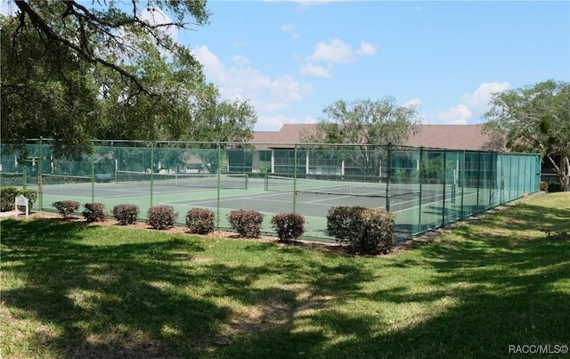 view of sport court featuring a lawn