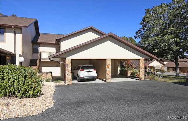 view of front of house with a garage and a carport