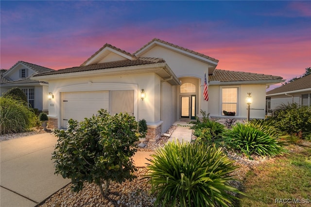 mediterranean / spanish-style home featuring a garage