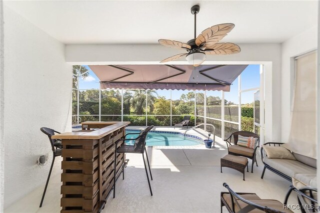 sunroom / solarium with ceiling fan and a healthy amount of sunlight