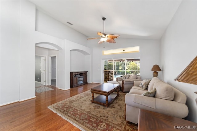 902 W Silver Meadow Loop, Hernando, FL 34442 - living area with wood finished floors, a ceiling fan, a fireplace, high vaulted ceiling, and arched walkways