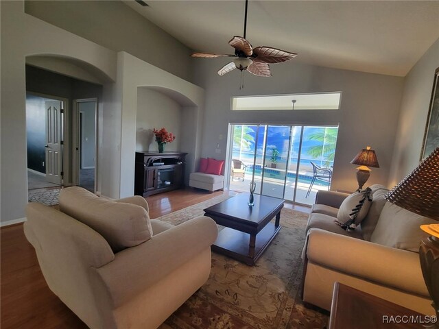 902 W Silver Meadow Loop, Hernando, FL 34442 - living area with ceiling fan, high vaulted ceiling, wood finished floors, and a wood stove