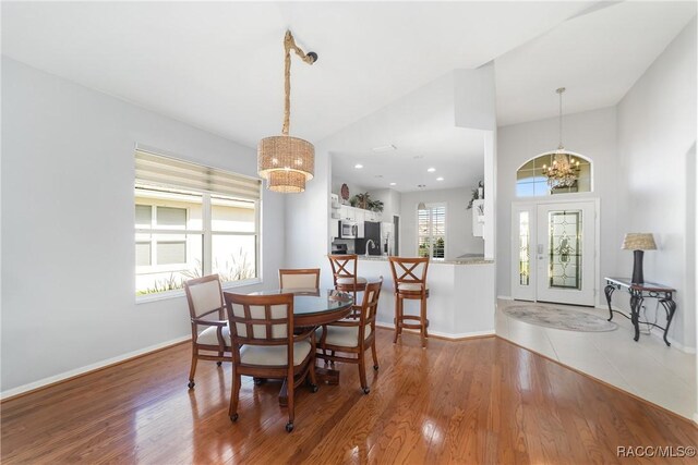 kitchen featuring white cabinets, stainless steel appliances, lofted ceiling, and sink