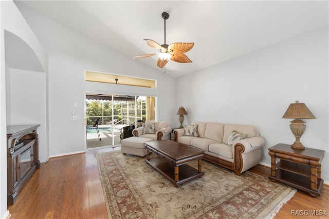 living room featuring hardwood / wood-style floors, vaulted ceiling, and ceiling fan