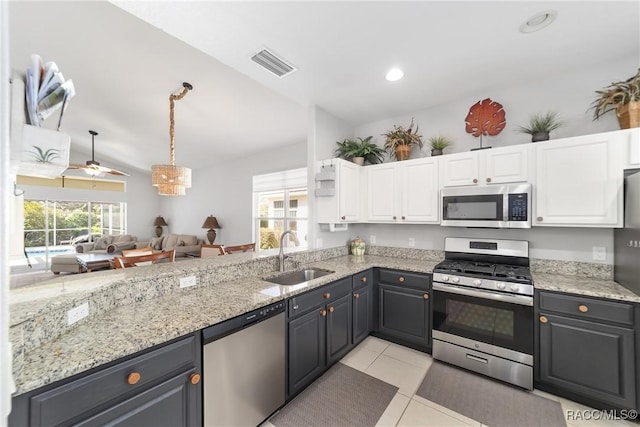 902 W Silver Meadow Loop, Hernando, FL 34442 - kitchen featuring appliances with stainless steel finishes, a sink, white cabinetry, light tile patterned floors, and lofted ceiling