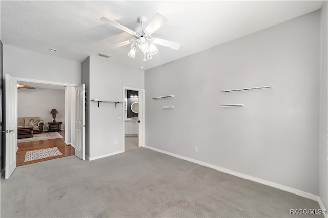 unfurnished bedroom featuring ceiling fan and carpet