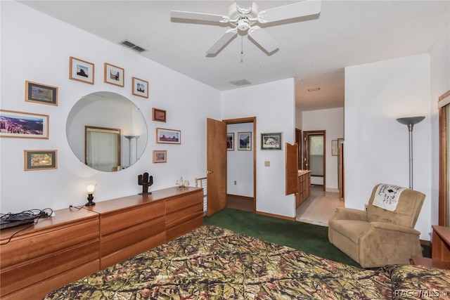 bedroom featuring carpet flooring, ensuite bathroom, and ceiling fan