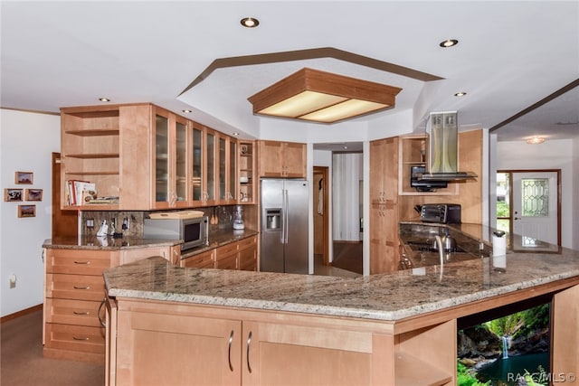 kitchen featuring kitchen peninsula, backsplash, light stone counters, stainless steel appliances, and extractor fan