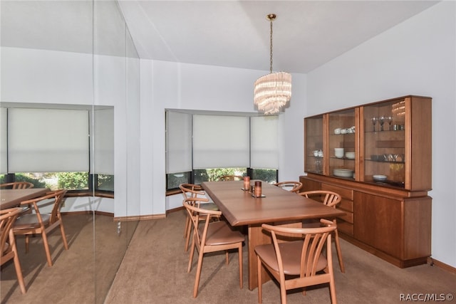 dining area featuring carpet floors and a chandelier