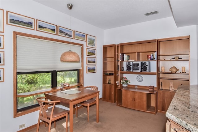 dining room featuring light carpet