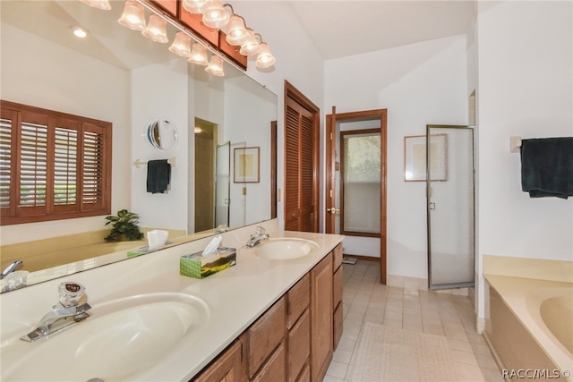 bathroom with tile patterned floors, vanity, and separate shower and tub