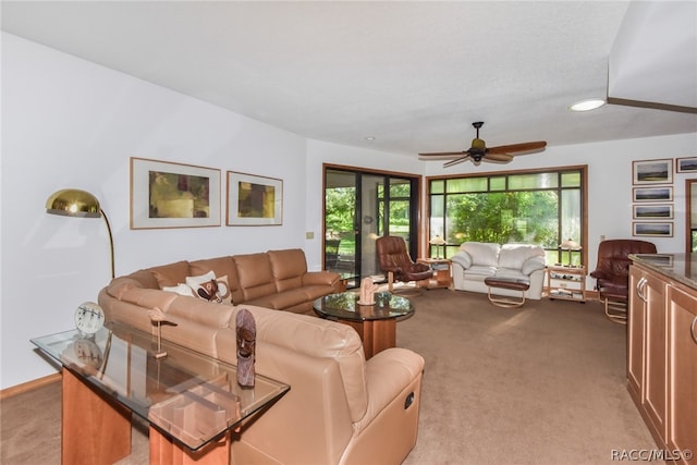 carpeted living room with ceiling fan