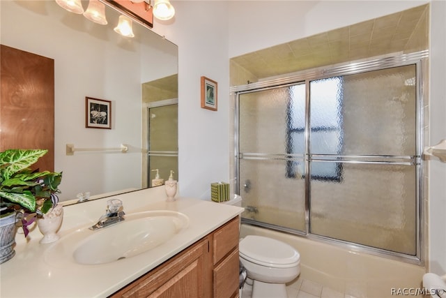 full bathroom with tile patterned floors, combined bath / shower with glass door, toilet, and vanity