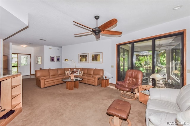 carpeted living room featuring ceiling fan