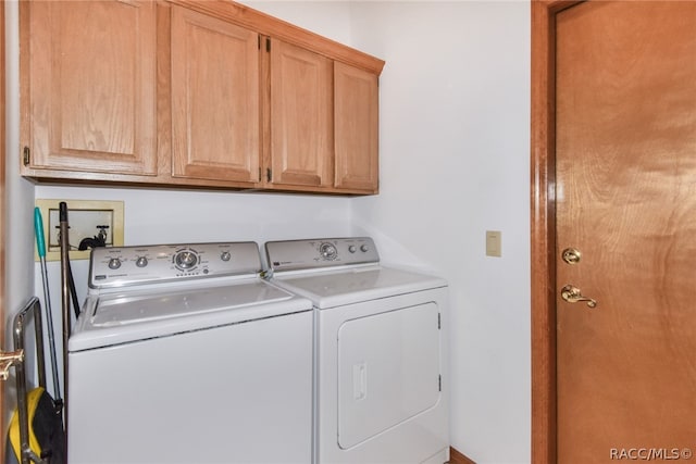 laundry area featuring washer and dryer and cabinets