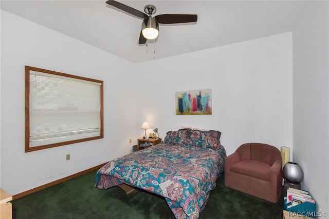 bedroom featuring ceiling fan and dark carpet