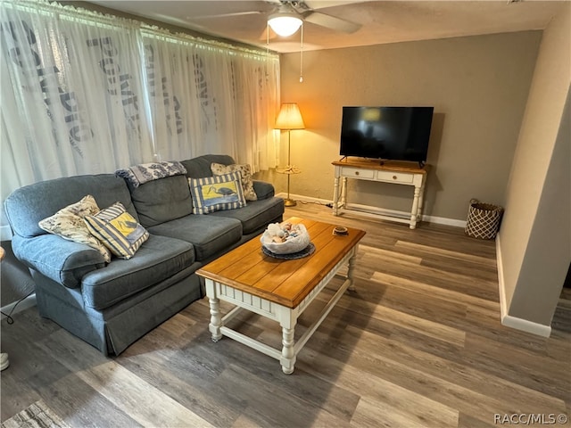 living room featuring hardwood / wood-style floors and ceiling fan