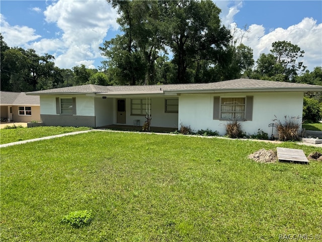 ranch-style home with a front lawn