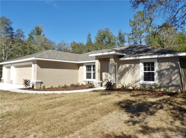 view of front of property featuring a garage and a front lawn