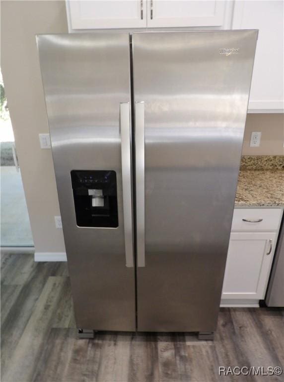 room details featuring white cabinetry, stainless steel fridge, and dark hardwood / wood-style floors