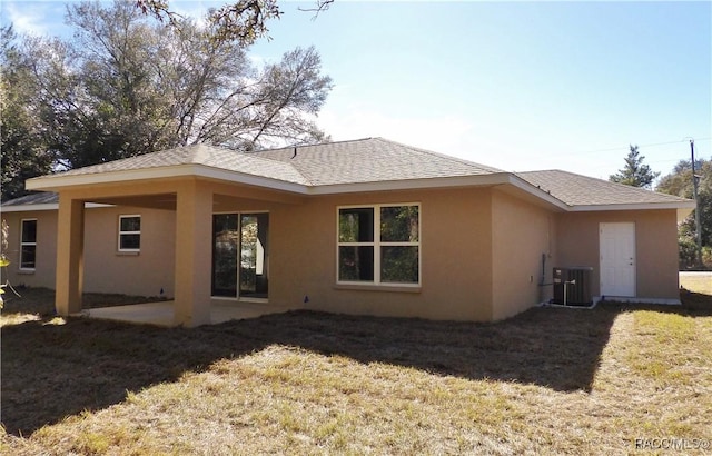 back of property featuring a yard, a patio area, and central air condition unit