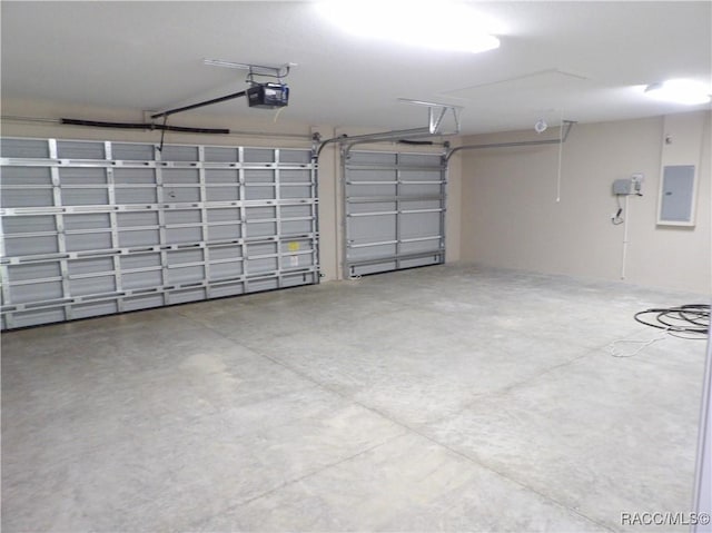 garage with electric panel and a garage door opener