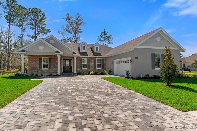 view of front of house featuring a garage and a front lawn