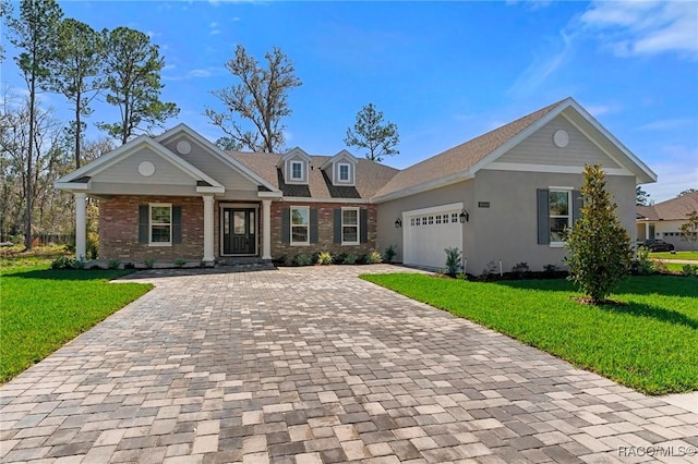 view of front facade with a garage, a front lawn, decorative driveway, and brick siding